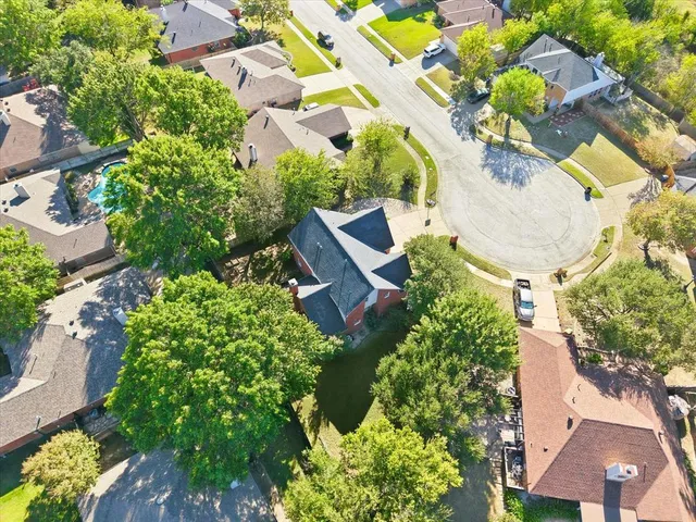 an aerial view of a house with a yard and garden
