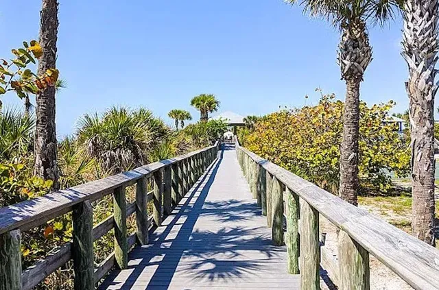 a view of a balcony with wooden floor and fence