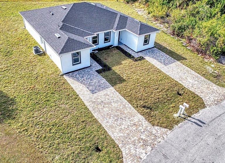 10249 Burlington Avenue Englewood, FL 34224 - Photo 2 of 12 a front view of a house with a yard