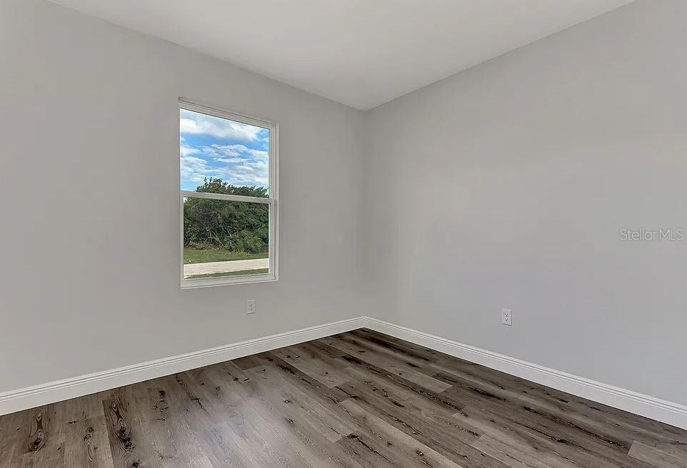 10249 Burlington Avenue Englewood, FL 34224 - Photo 8 of 12 wooden floor in an empty room