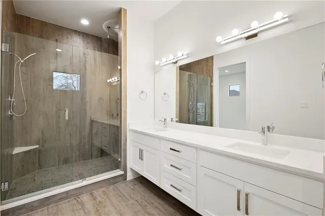 a bathroom with a shower sink and mirror