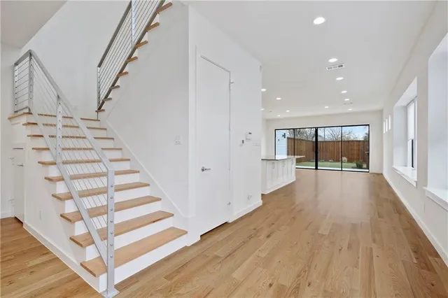 a view of entryway and hall with wooden floor
