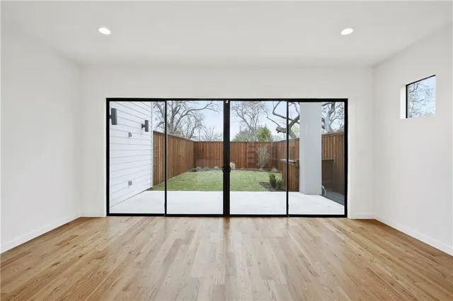 a view of a room with wooden floor and windows