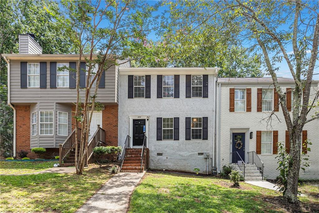 1654 Cedar Bluff Way Marietta, GA 30062 - Photo 1 of 1 a front view of a house with garden
