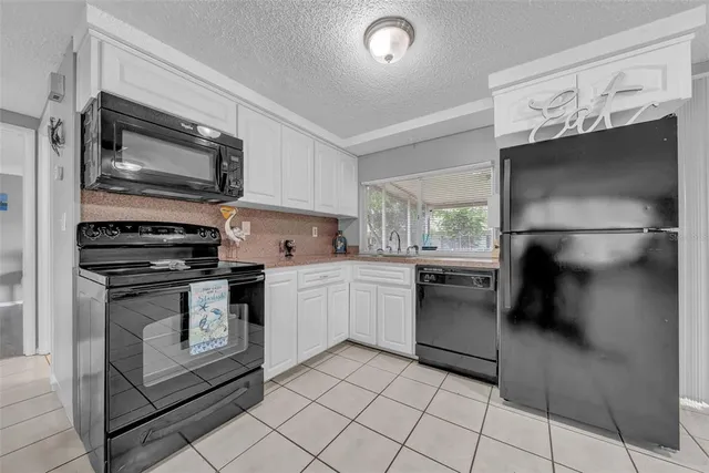 a kitchen with a refrigerator stove and cabinets