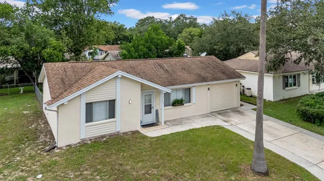 a white house that has tree in front of it