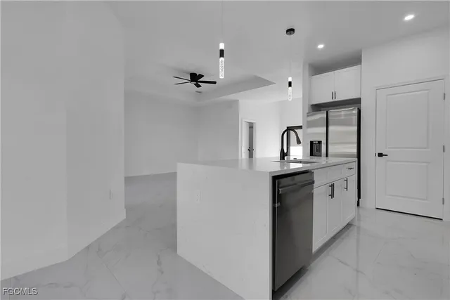 a kitchen with stainless steel appliances a refrigerator and a sink