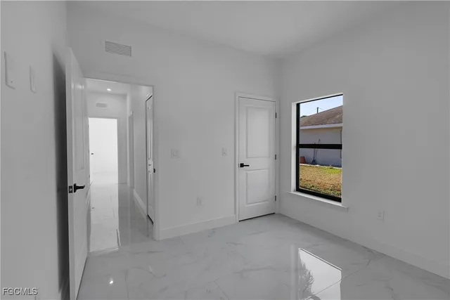 a bathroom with a toilet a sink a mirror and vanity