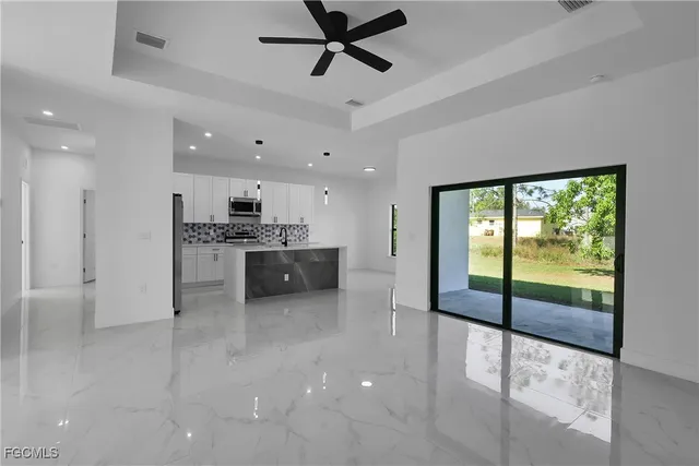 a view of a kitchen with a sink and stainless steel appliances