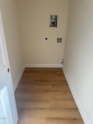 a view of a room with wooden floor