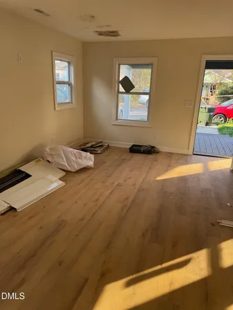 a bedroom with a bed and painting on the wall