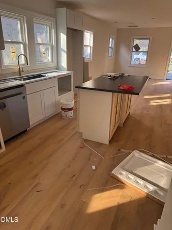 a kitchen with granite countertop a sink and a stove