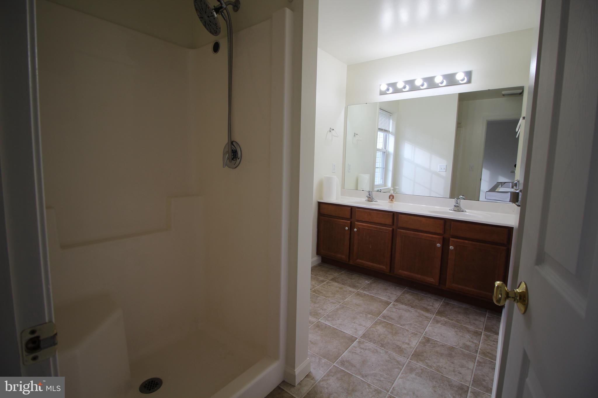 16 Bradford Drive Leola, PA 17540 - Photo 6 of 11 a bathroom with a double vanity sink mirror and shower
