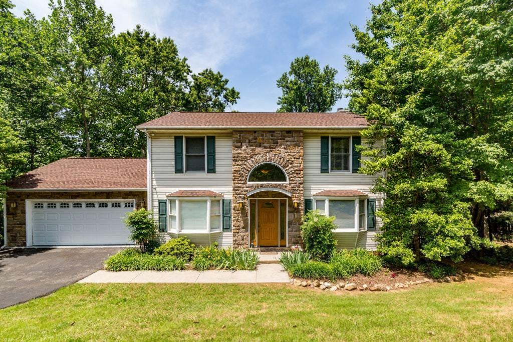 121 Oak Ridge Court Blue Ridge, VA 24064 - Photo 1 of 63 a front view of a house with a yard