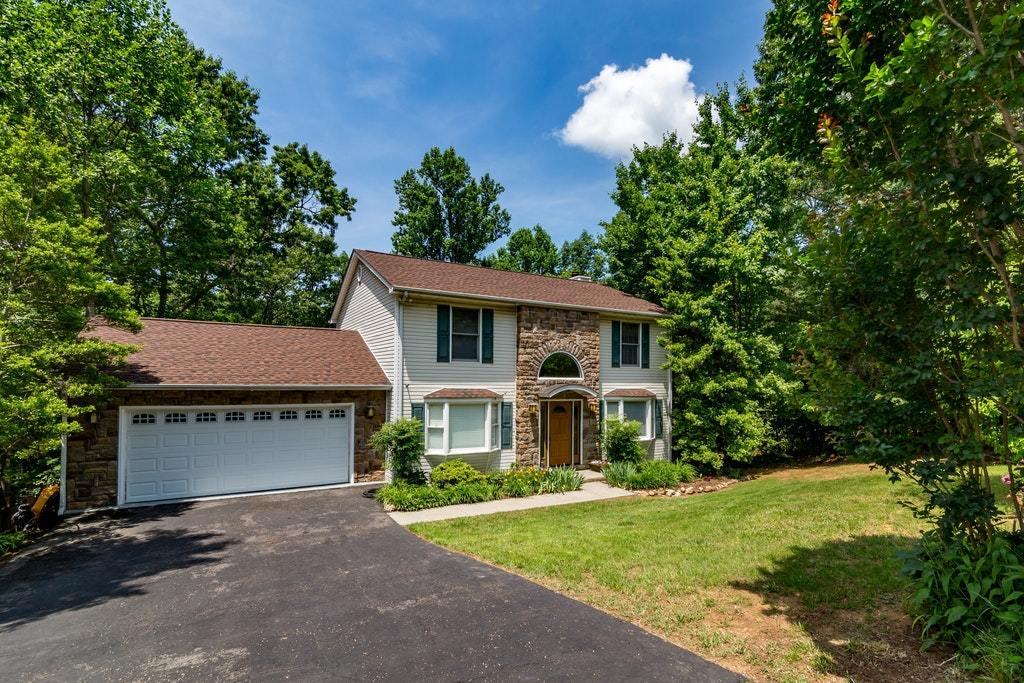 121 Oak Ridge Court Blue Ridge, VA 24064 - Photo 2 of 63 a front view of a house with a yard and garage