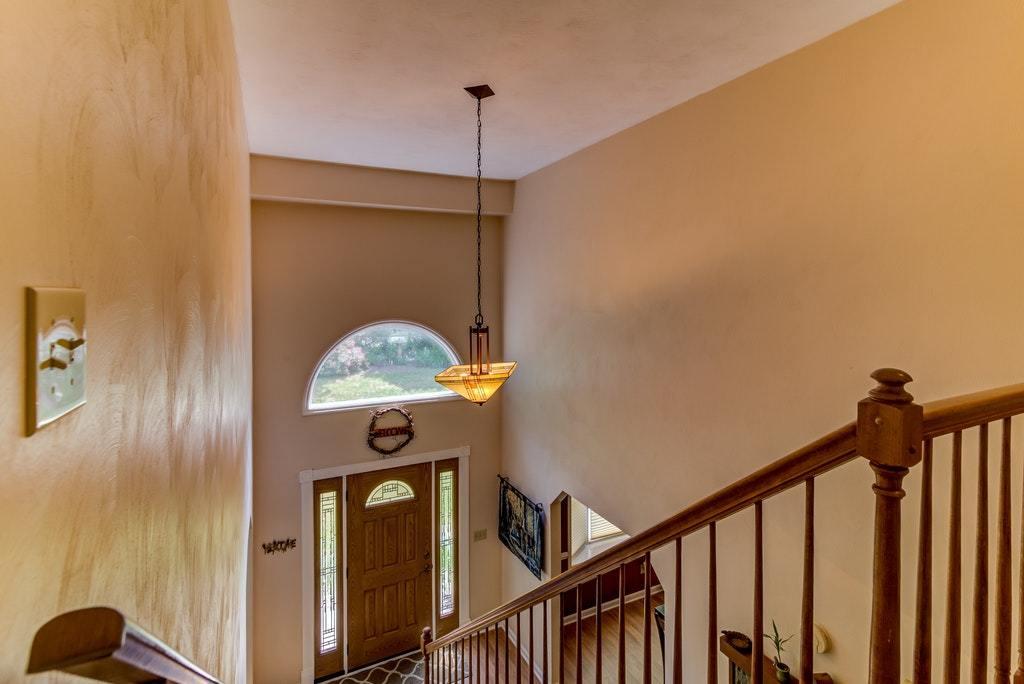 121 Oak Ridge Court Blue Ridge, VA 24064 - Photo 19 of 63 a view of a hallway with entryway wooden floor and front door