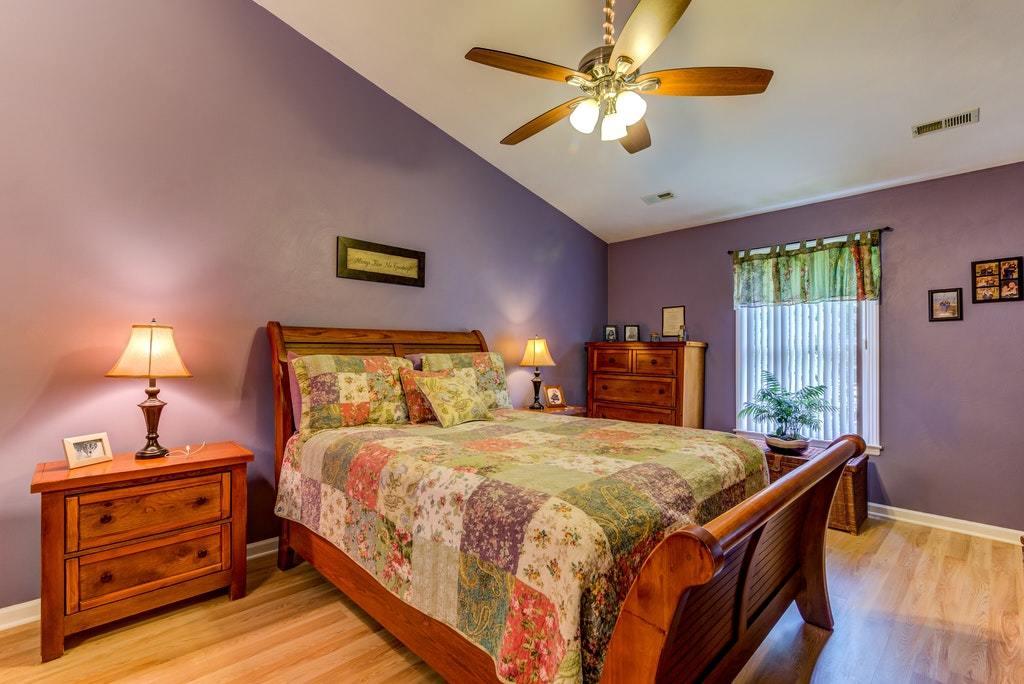 121 Oak Ridge Court Blue Ridge, VA 24064 - Photo 22 of 63 a bedroom with a bed and a chandelier