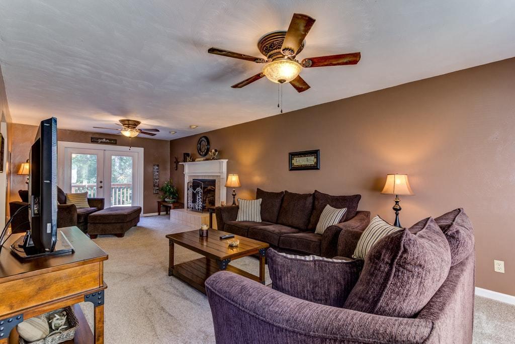 121 Oak Ridge Court Blue Ridge, VA 24064 - Photo 5 of 63 a living room with furniture ceiling fan and a fireplace