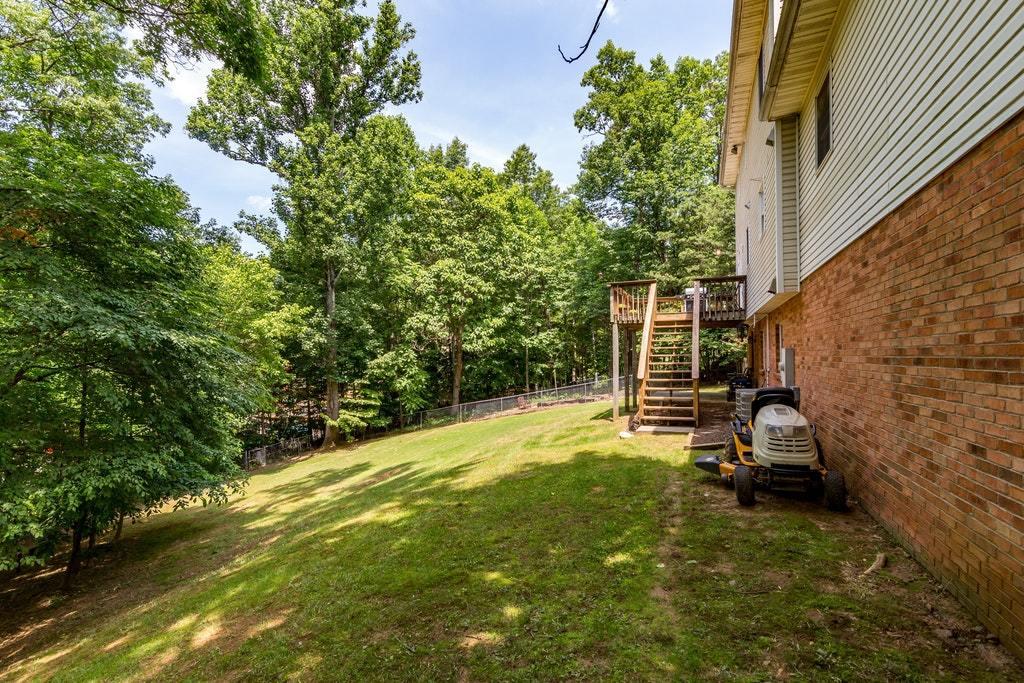 121 Oak Ridge Court Blue Ridge, VA 24064 - Photo 48 of 63 a backyard of a house with a yard and seating area