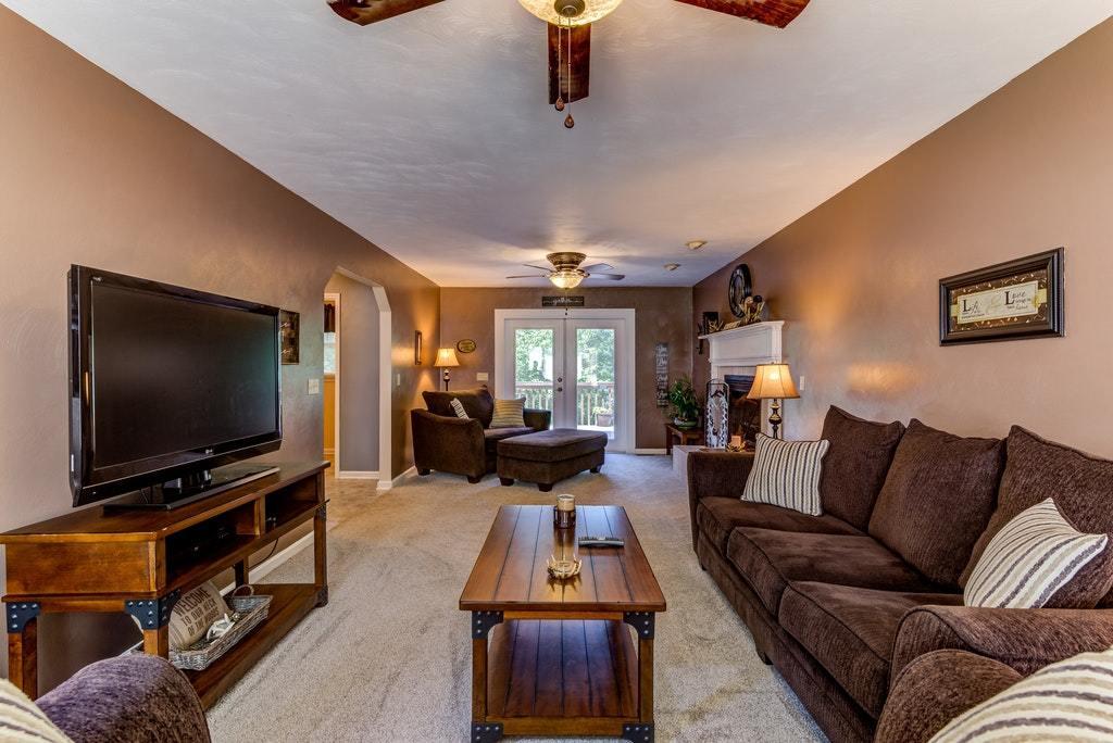 121 Oak Ridge Court Blue Ridge, VA 24064 - Photo 6 of 63 a living room with furniture and a flat screen tv