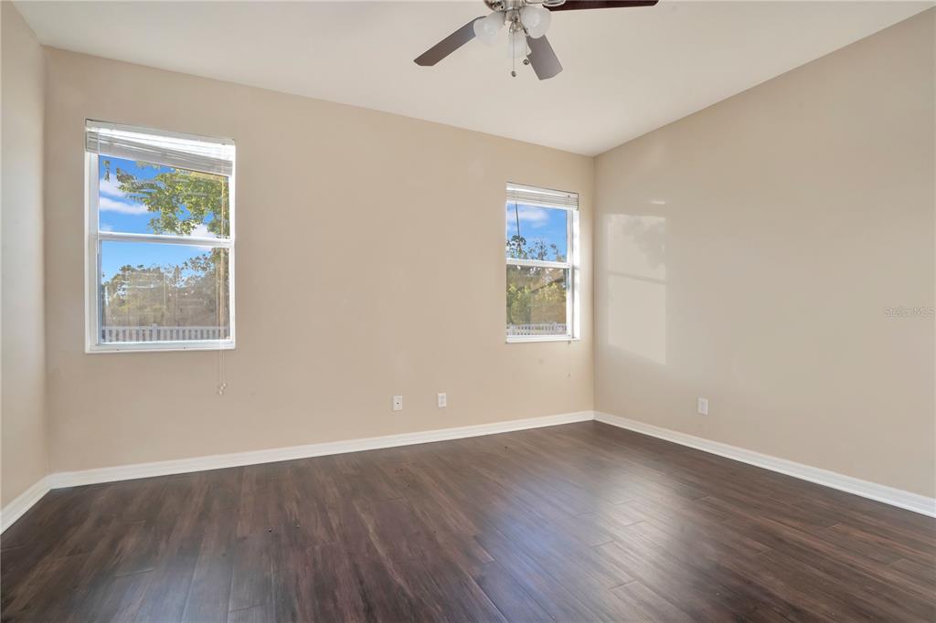 15031 Skip Jack Loop Lakewood Ranch, FL 34202 - Photo 13 of 27 a view of an empty room with wooden floor and a window