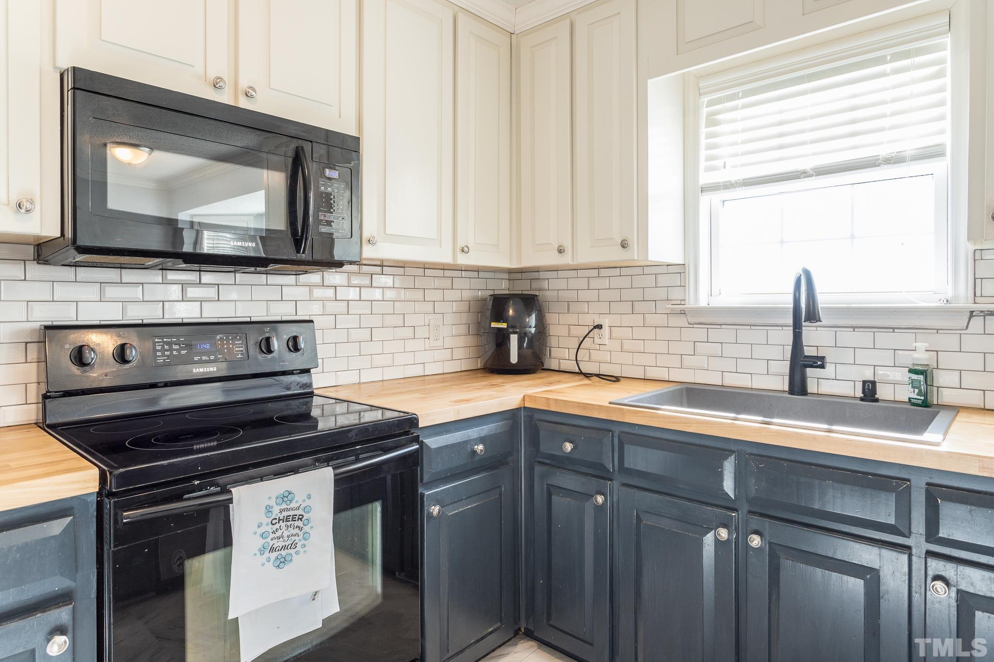 1004 Holland Ridge Drive Raleigh, NC 27603 - Photo 14 of 37 a kitchen with a sink stove and cabinets