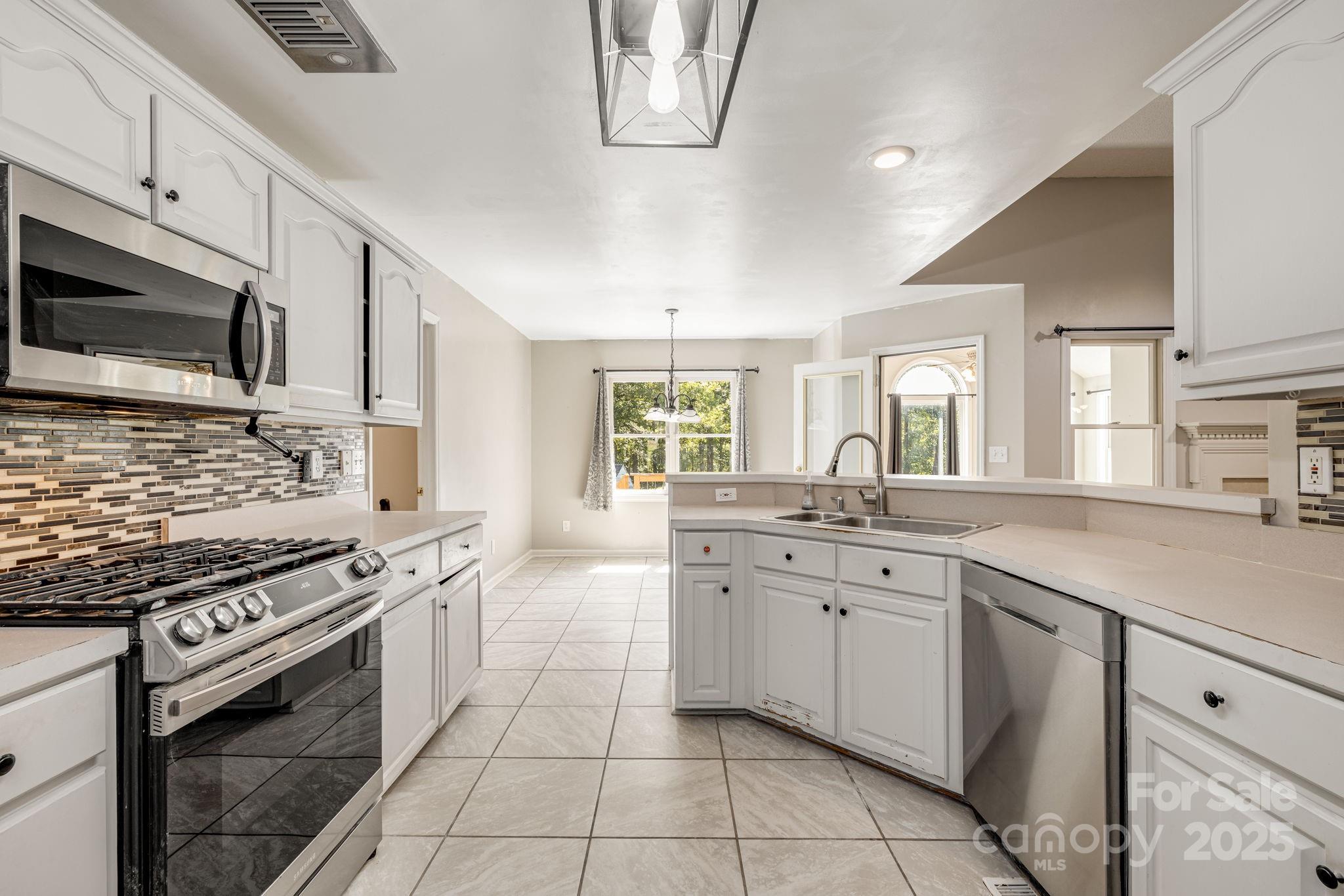 110 Ritchie Drive Shelby, NC 28152 - Photo 12 of 48 a kitchen with stainless steel appliances granite countertop a stove and a sink