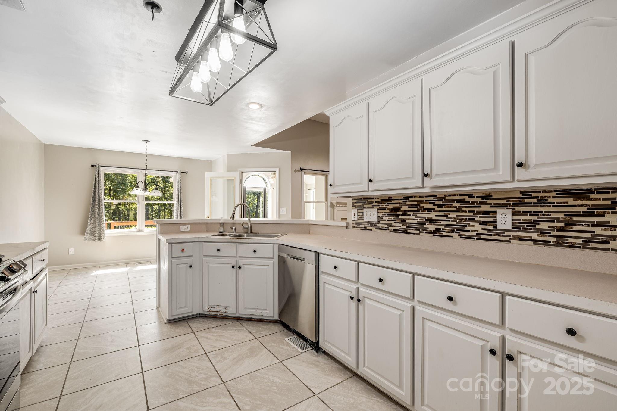 110 Ritchie Drive Shelby, NC 28152 - Photo 13 of 48 a kitchen with granite countertop white cabinets white appliances with a sink and dishwasher