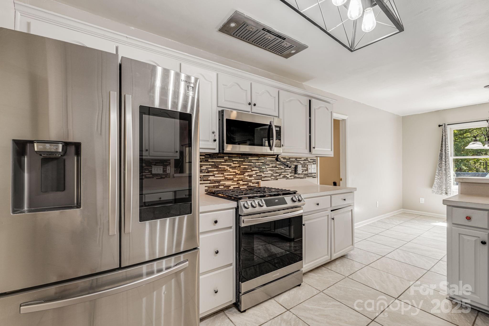 110 Ritchie Drive Shelby, NC 28152 - Photo 14 of 48 a kitchen with stainless steel appliances granite countertop a stove a refrigerator and a microwave