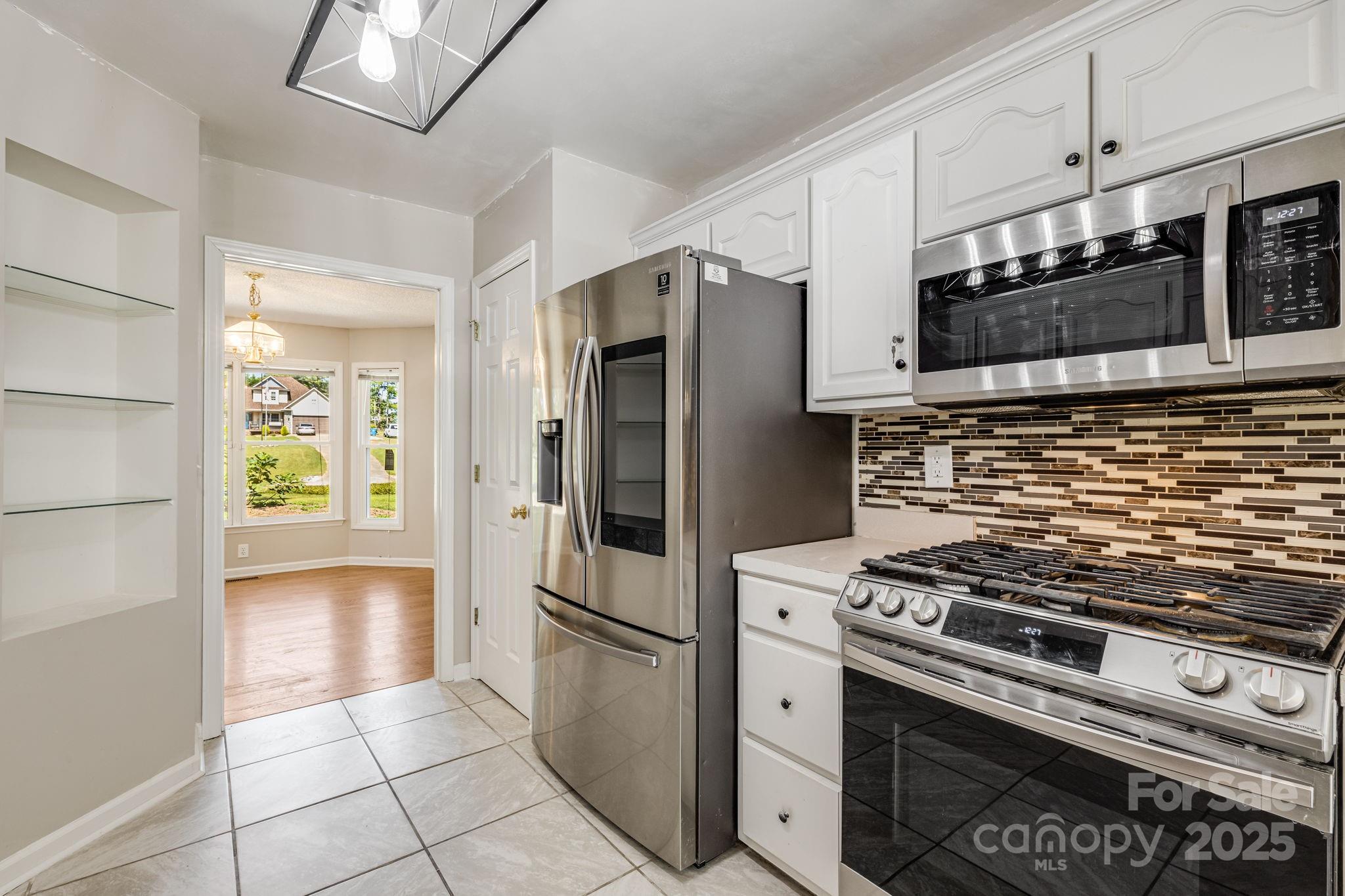 110 Ritchie Drive Shelby, NC 28152 - Photo 15 of 48 a kitchen with stainless steel appliances a stove a microwave and a refrigerator