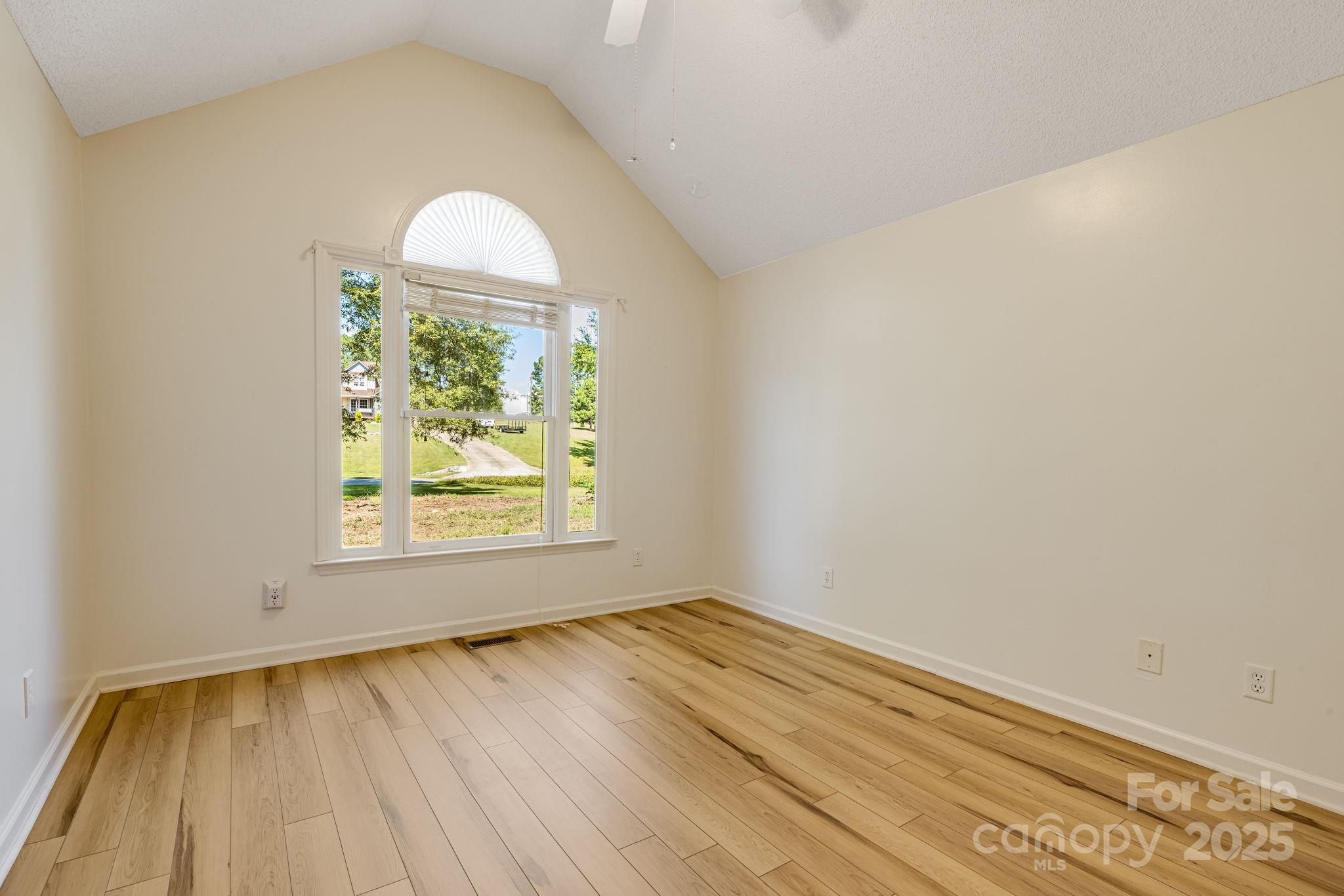 110 Ritchie Drive Shelby, NC 28152 - Photo 20 of 48 an empty room with wooden floor a exposed radiator and a window