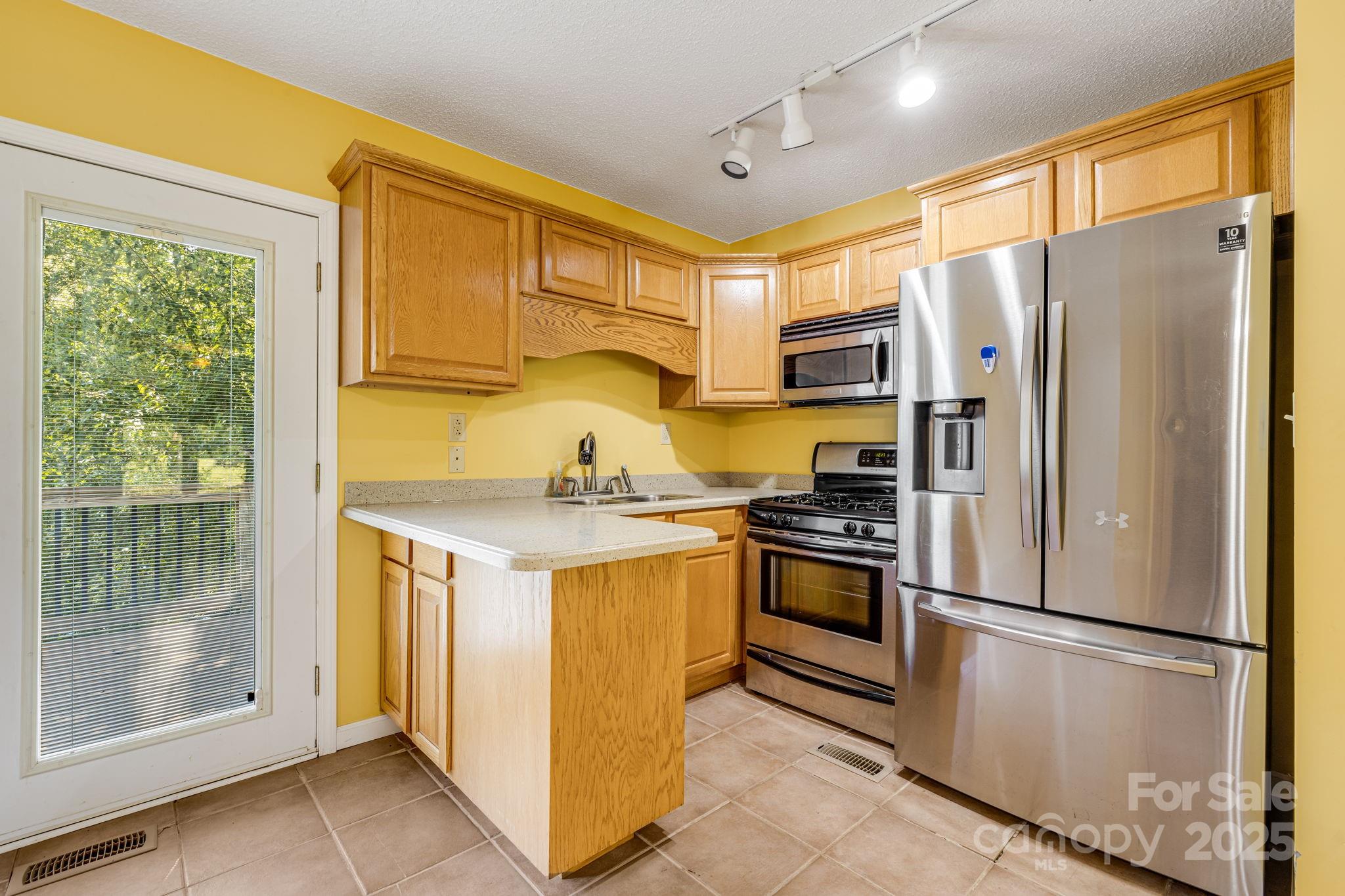 110 Ritchie Drive Shelby, NC 28152 - Photo 33 of 48 a kitchen with stainless steel appliances a refrigerator sink and cabinets