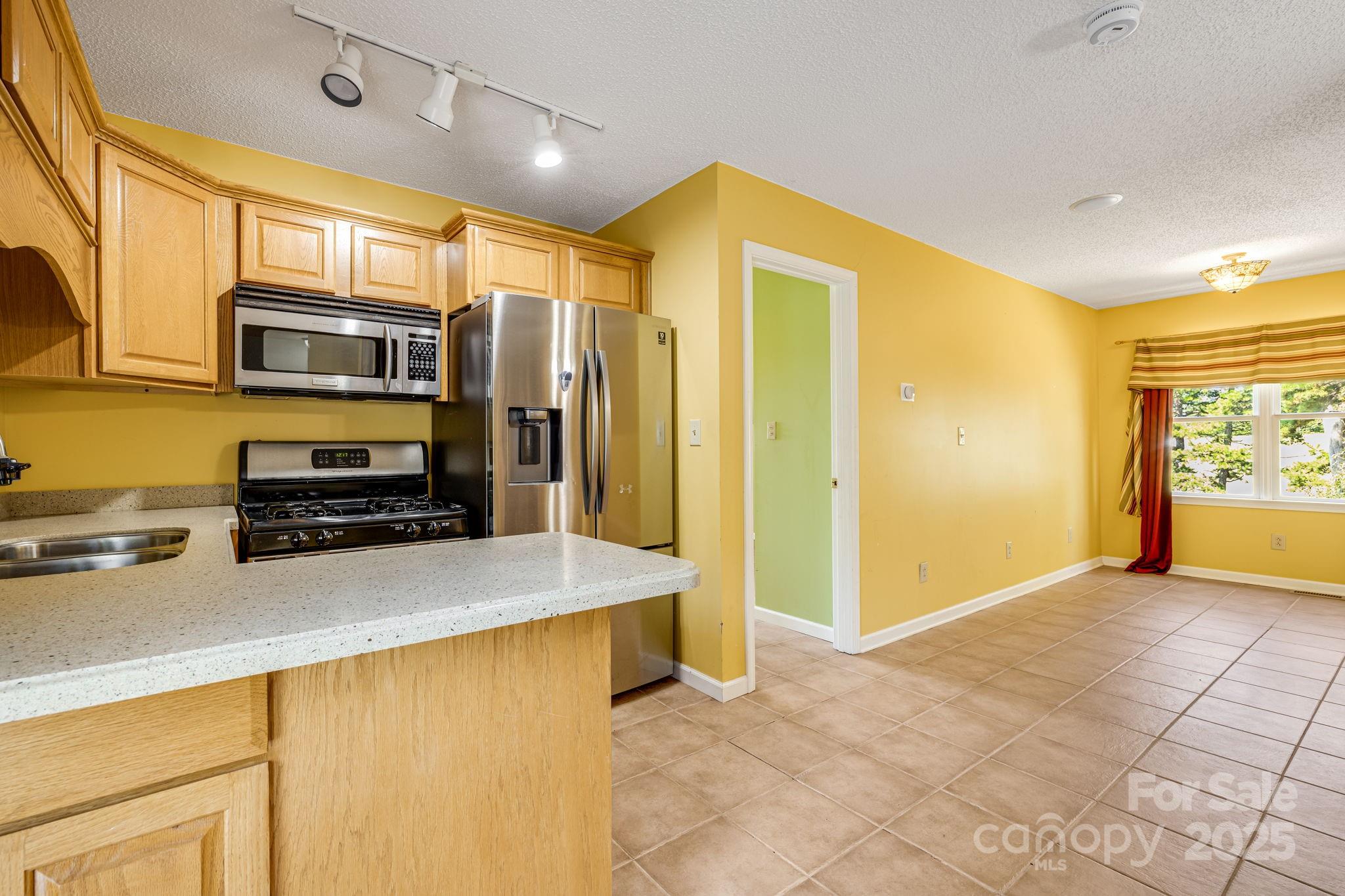 110 Ritchie Drive Shelby, NC 28152 - Photo 34 of 48 a kitchen with stainless steel appliances a stove a microwave and a refrigerator