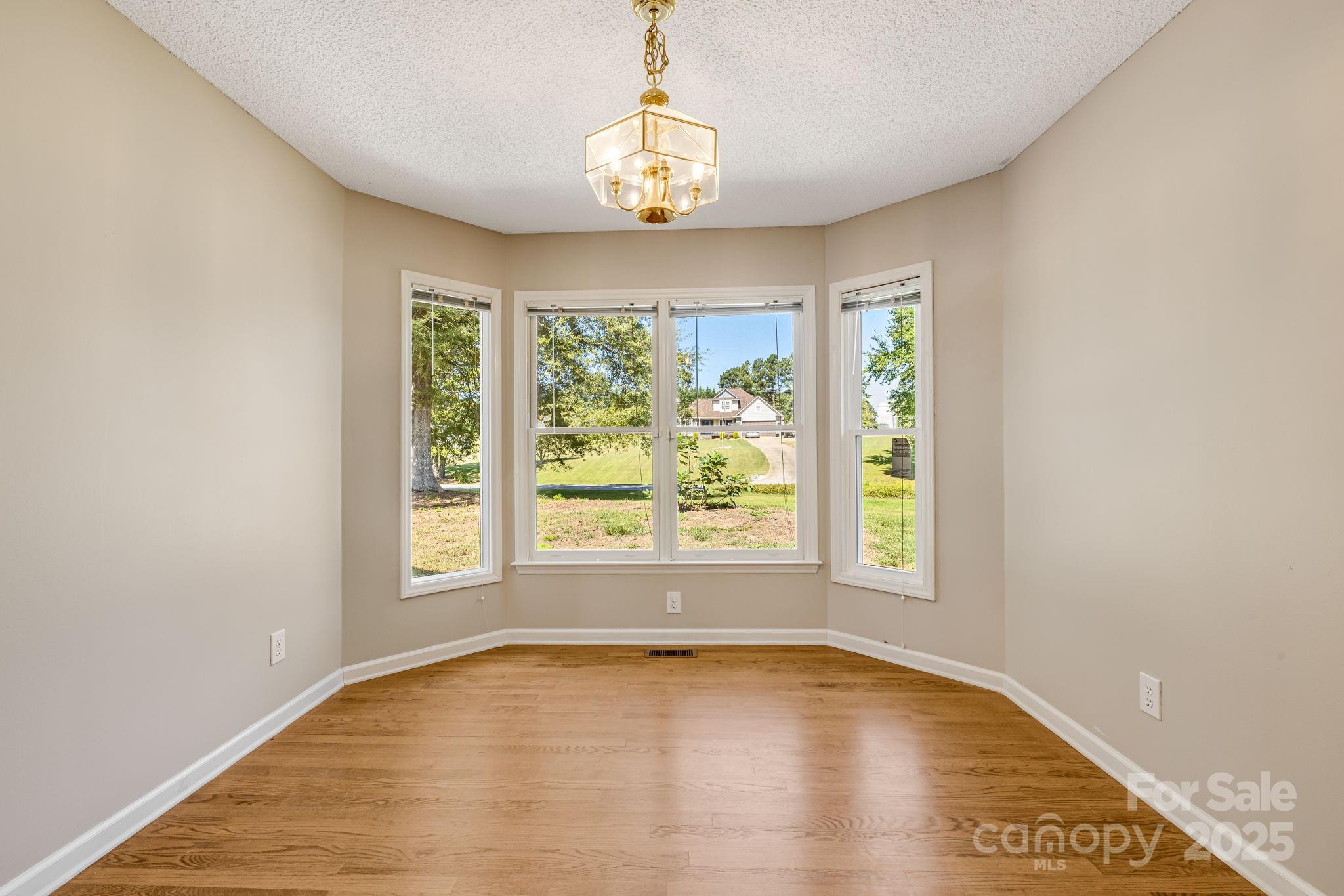 110 Ritchie Drive Shelby, NC 28152 - Photo 7 of 48 an empty room with wooden floor and windows
