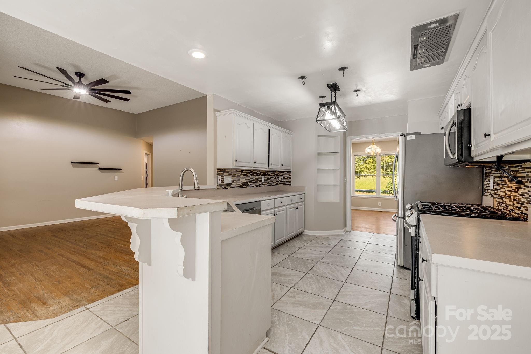 110 Ritchie Drive Shelby, NC 28152 - Photo 9 of 48 a kitchen with kitchen island granite countertop a sink appliances cabinets and furniture