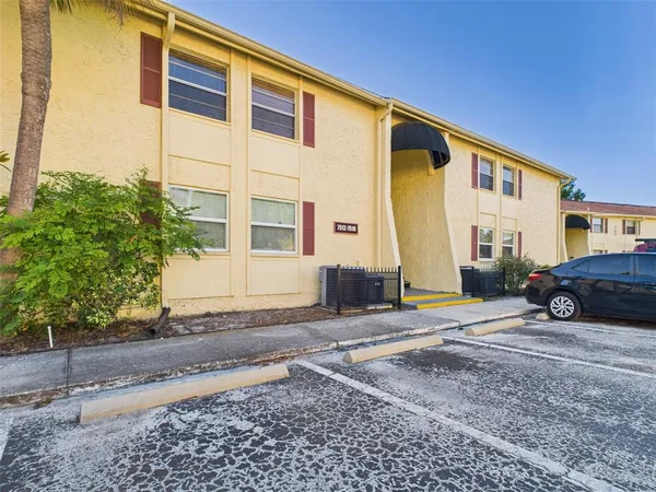 a couple of cars parked in front of a house