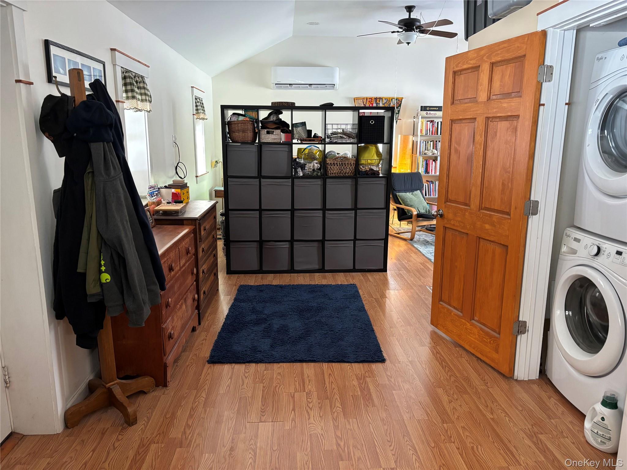 273 South Road Holmes, NY 12531 - Photo 5 of 13 Laundry area featuring light wood-style flooring, stacked washer and clothes dryer, lofted ceiling, and a ceiling fan