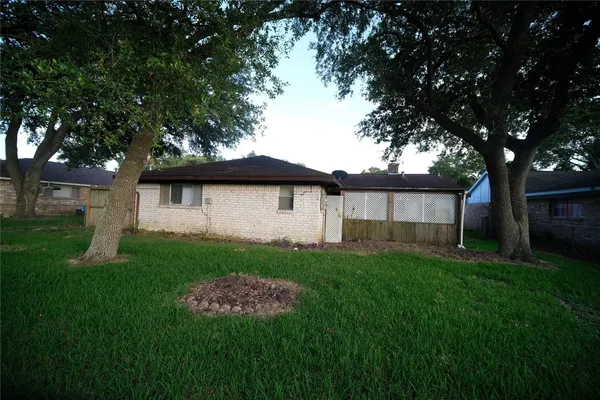 a view of a backyard with a large tree