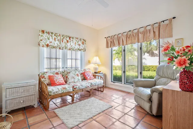 a living room with furniture and a floor to ceiling window