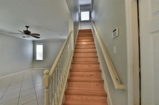 a spacious bathroom with a granite countertop sink a toilet a mirror and shower