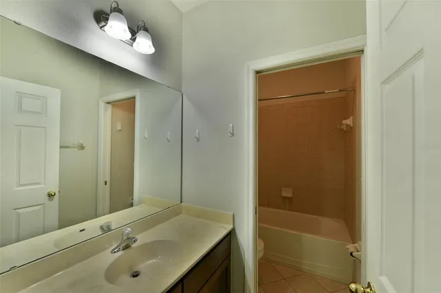 an empty room with wooden floor and cabinet