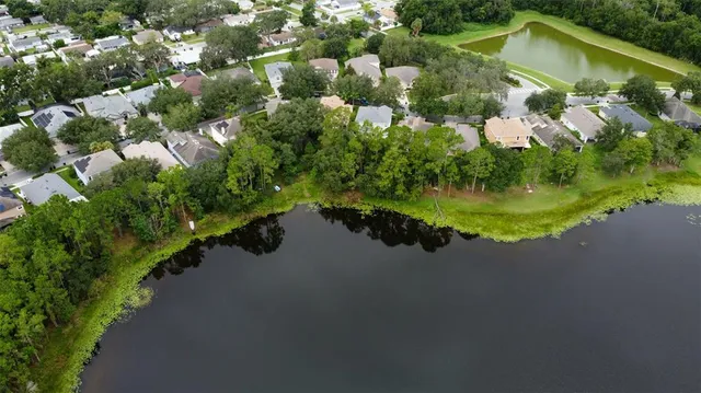 a view of a house with a yard and lake