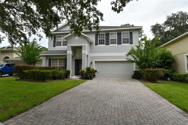 an aerial view of a house with garden space and lake view