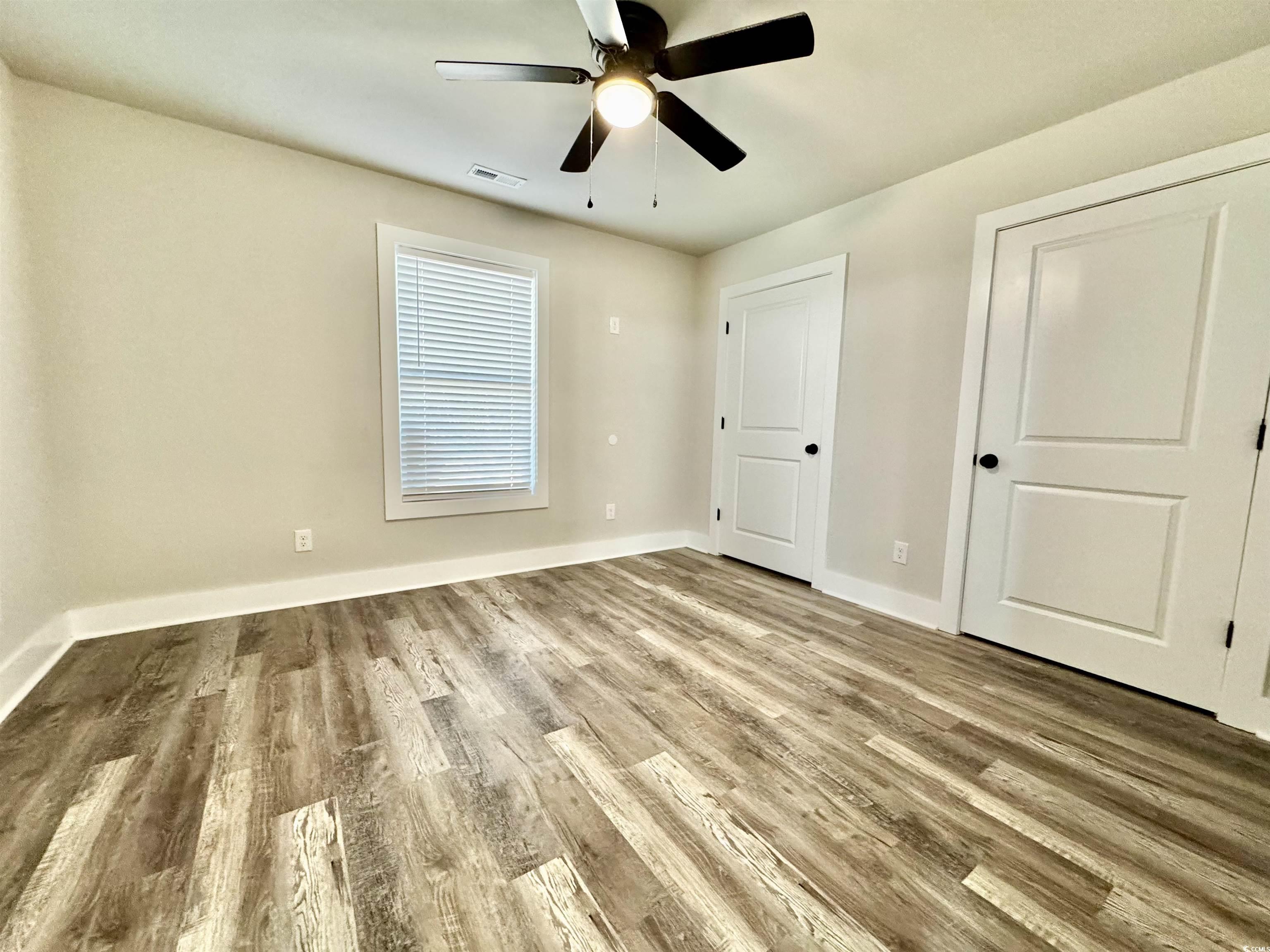 3216 South Hill Road Timmonsville, SC 29161 - Photo 8 of 19 Unfurnished bedroom with light wood-type flooring and ceiling fan