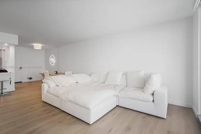 a large white bed in a white room