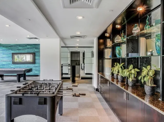 a kitchen with stainless steel appliances kitchen island granite countertop a stove a sink and a dining table