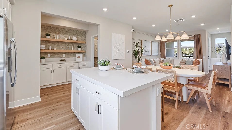 1720 East Park Lane, Unit 11 Anaheim, CA 92805 - Photo 1 of 25 a kitchen with a table chairs stove and cabinets