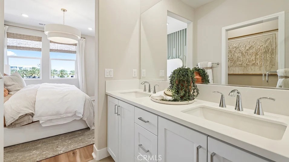 1720 East Park Lane, Unit 11 Anaheim, CA 92805 - Photo 12 of 25 a en suite bathroom with a double vanity sink and a large mirror