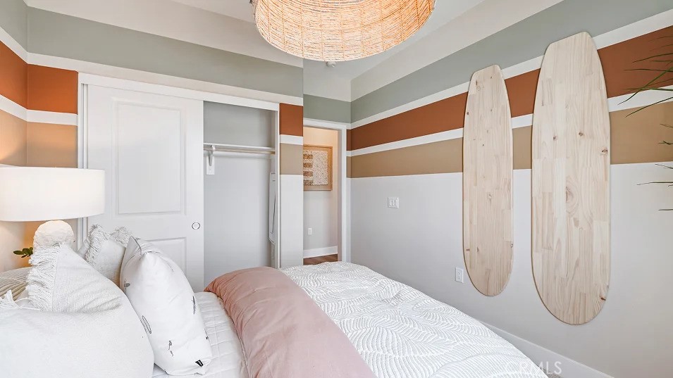 1720 East Park Lane, Unit 11 Anaheim, CA 92805 - Photo 16 of 25 a bedroom with a bed and a mirror