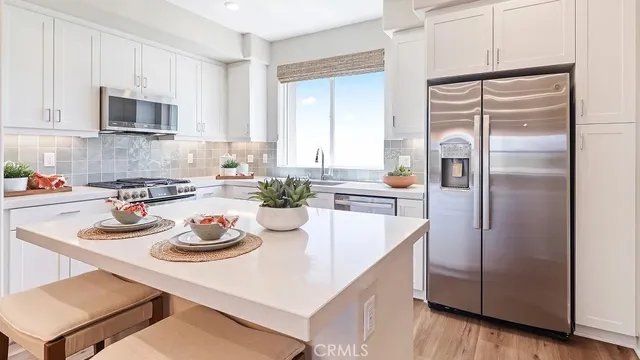 a kitchen with refrigerator and cabinets